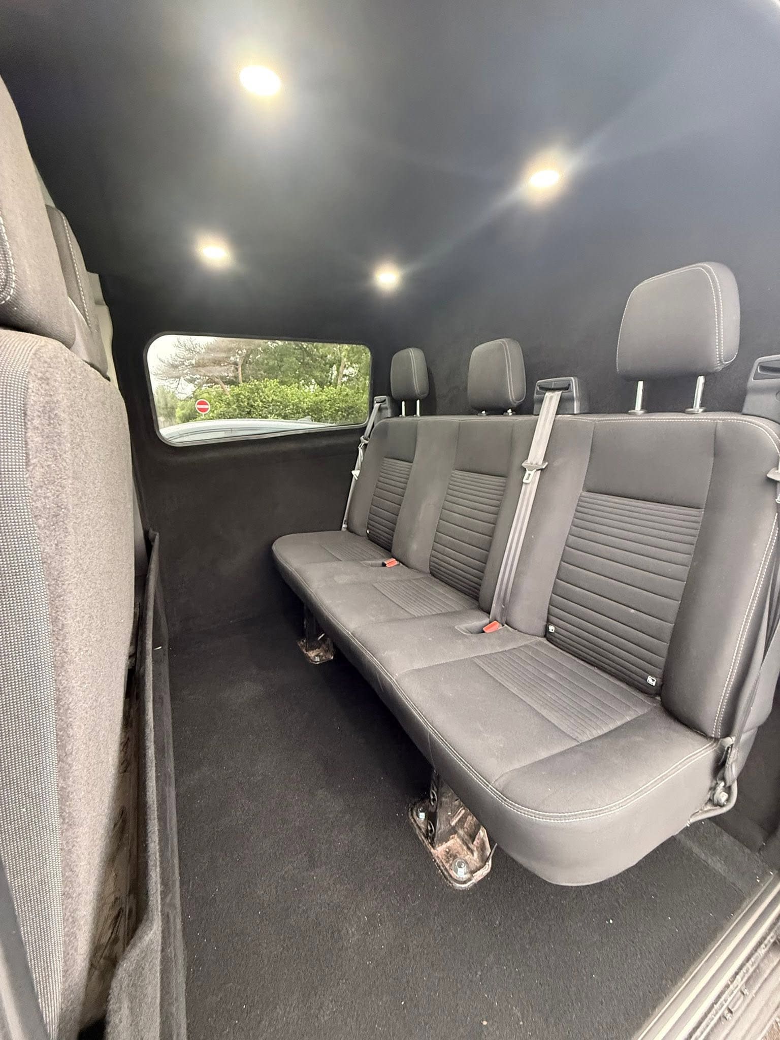 Van after a crew cab conversion with a second row of seats