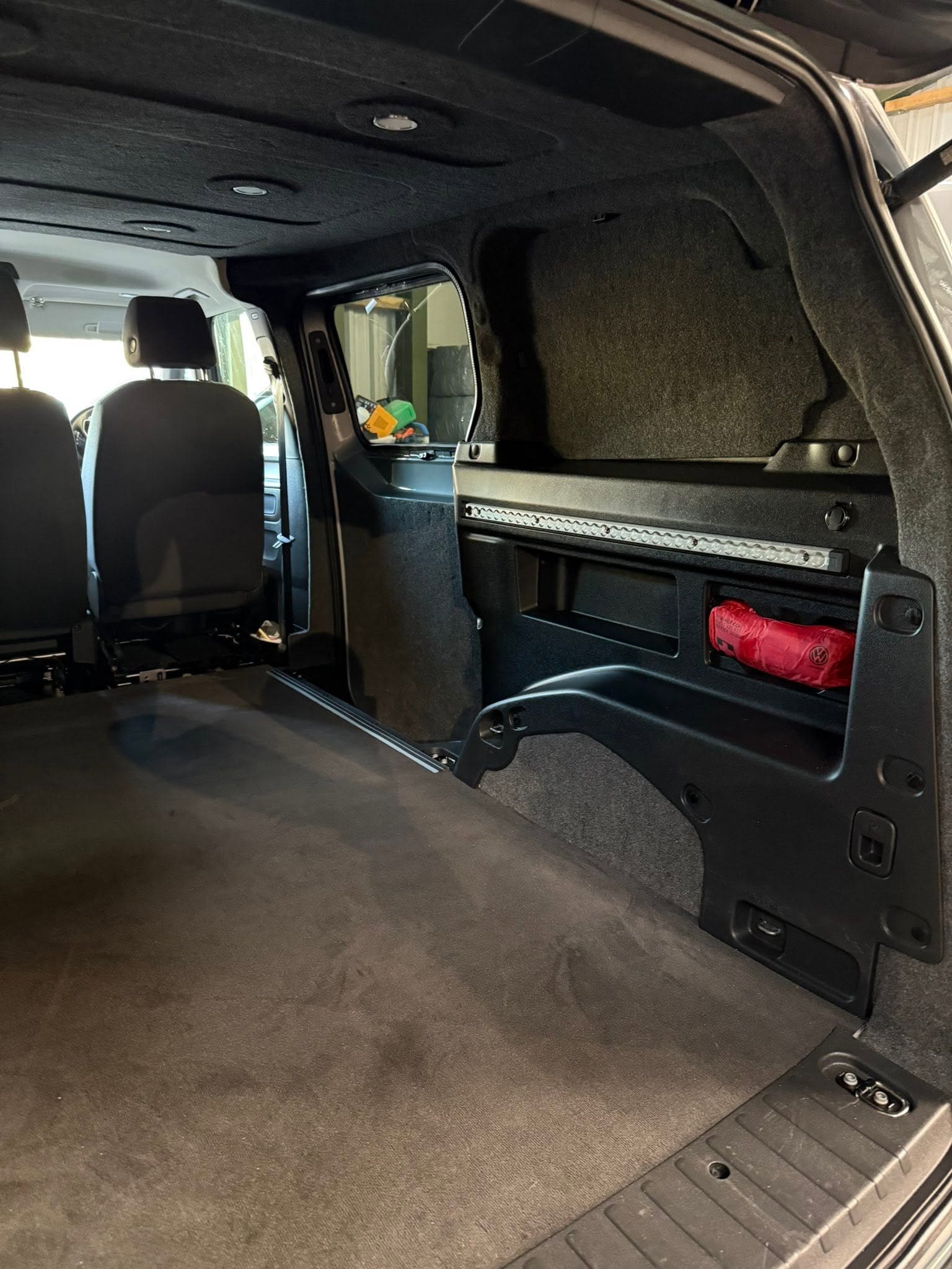 Careful carpet lining work in progress inside a van