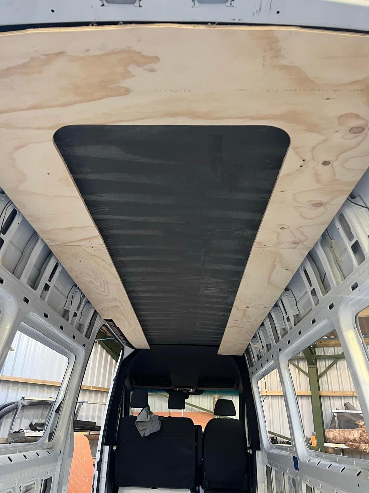 Van ceiling being lined in ply during a conversion in the Cardiff workshop